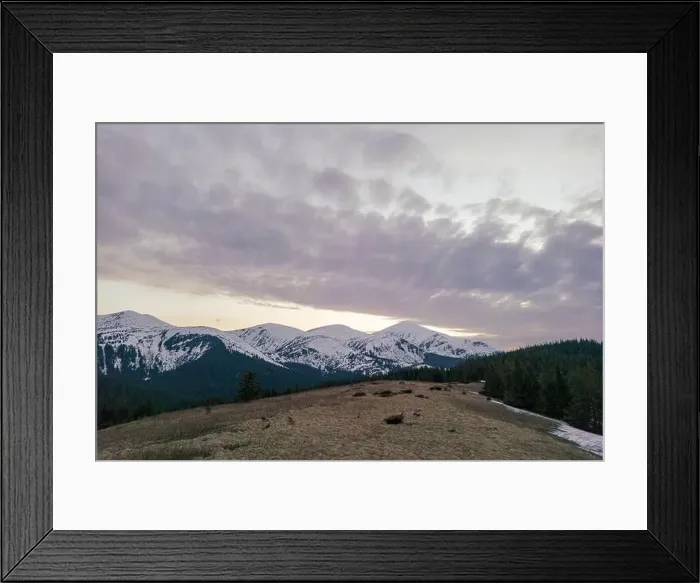 Framed Print : A snowy Carpathian mountain range with a violet sky and clouds in the background Framed Print : A snowy Carpathian mountain range with a violet sky and clouds in the background