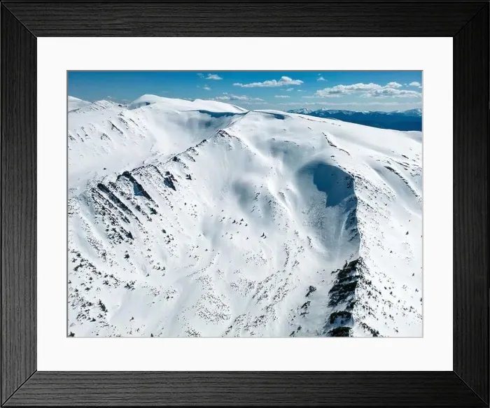 Framed Print : A top view of a snowy mountain range Kizly with a blue sky and clouds in the background. Carpathian mountain range Framed Print : A top view of a snowy mountain range Kizly with a blue sky and clouds in the background. Carpathian mountain range