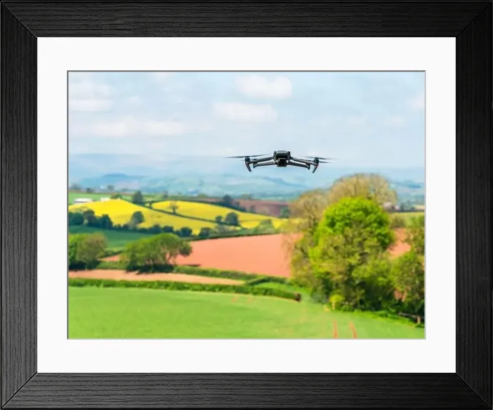 Framed Print : Drone in flight over fields and farms, Devon, England Framed Print : Drone in flight over fields and farms, Devon, England