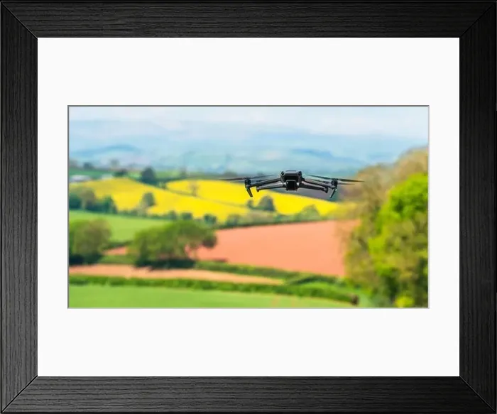 Framed Print : Drone in flight over fields and farms, Devon, England Framed Print : Drone in flight over fields and farms, Devon, England