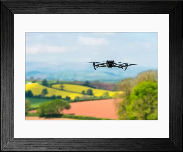 Framed Print : Drone in flight over fields and farms, Devon, England Framed Print : Drone in flight over fields and farms, Devon, England