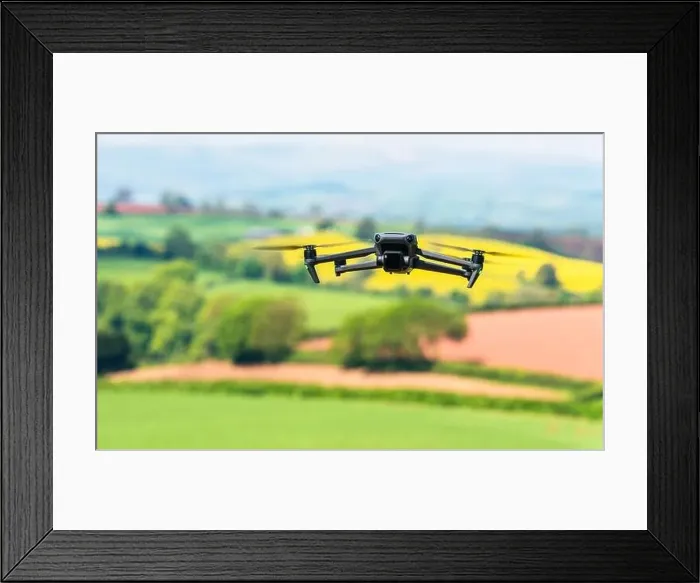 Framed Print : Drone in flight over fields and farms, Devon, England Framed Print : Drone in flight over fields and farms, Devon, England