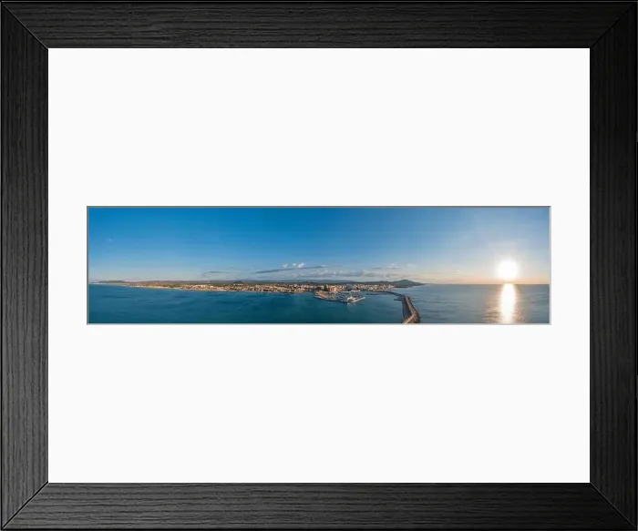 Framed Print : Drone panorama of the Spanish town of Vinaros with the large breakwater at the entrance to the port during sunrise in Framed Print : Drone panorama of the Spanish town of Vinaros with the large breakwater at the entrance to the port during sunrise in