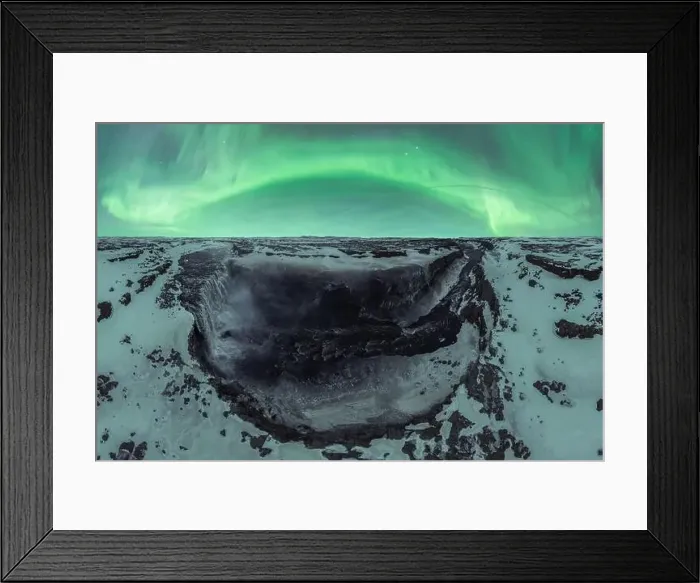 Framed Print : Wide angle aerial view of majestic scenery with bright green polar lights over snowy rocky formations in Iceland Framed Print : Wide angle aerial view of majestic scenery with bright green polar lights over snowy rocky formations in Iceland