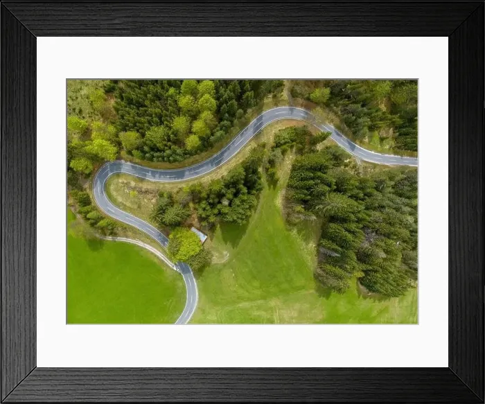 Framed Print : winding alpine road in the forest with green meadows and forests from a bird's eye view in the lechtal Framed Print : winding alpine road in the forest with green meadows and forests from a bird's eye view in the lechtal