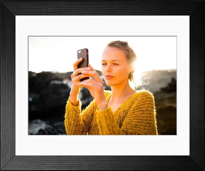 Framed Print : Pretty, young woman taking photos with her smartphone during her vacation Framed Print : Pretty, young woman taking photos with her smartphone during her vacation