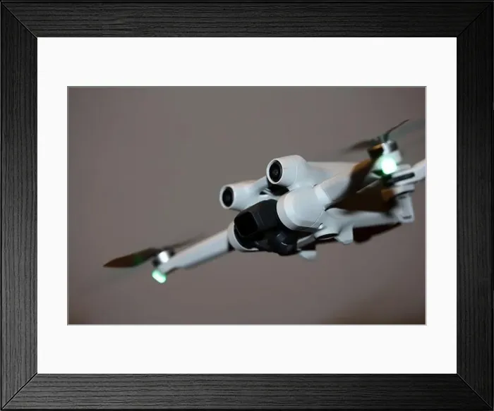 Framed Print : The drone copter flying with digital camera isolated on empty colorful background grey drones quad with sensors fly Framed Print : The drone copter flying with digital camera isolated on empty colorful background grey drones quad with sensors fly