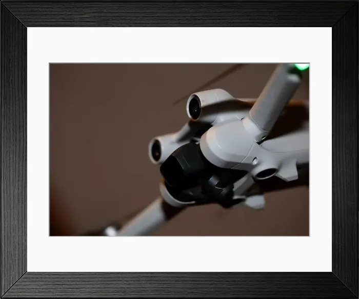 Framed Print : The drone copter flying with digital camera isolated on empty colorful background grey drones quad with sensors fly Framed Print : The drone copter flying with digital camera isolated on empty colorful background grey drones quad with sensors fly