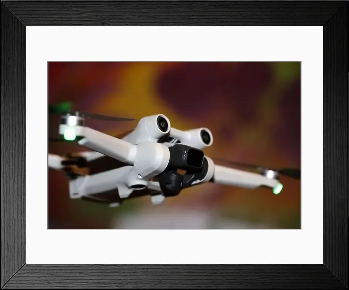 Framed Print : The drone copter flying with digital camera isolated on empty colorful background grey drones quad with sensors fly Framed Print : The drone copter flying with digital camera isolated on empty colorful background grey drones quad with sensors fly