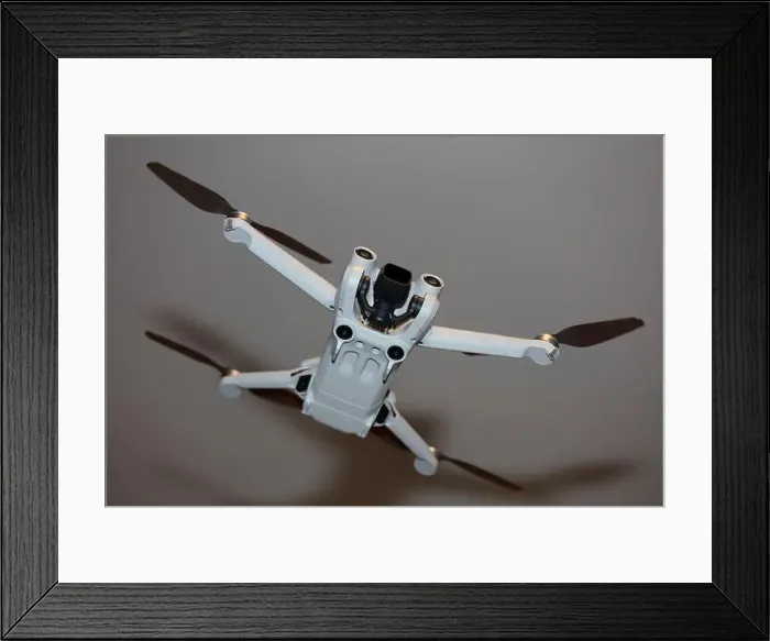 Framed Print : The drone copter flying with digital camera isolated on empty colorful background grey drones quad with sensors fly Framed Print : The drone copter flying with digital camera isolated on empty colorful background grey drones quad with sensors fly