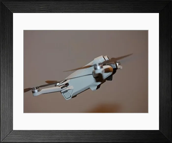 Framed Print : The drone copter flying with digital camera isolated on empty colorful background grey drones quad with sensors fly Framed Print : The drone copter flying with digital camera isolated on empty colorful background grey drones quad with sensors fly