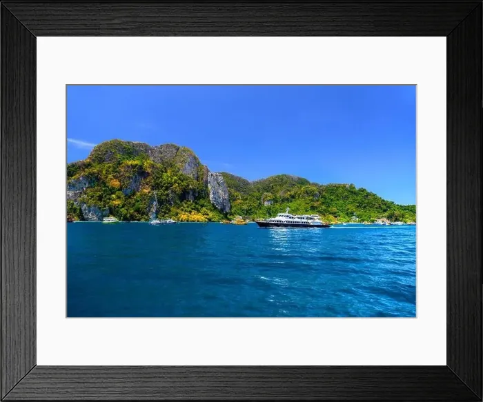 Framed Print : Motor ship in the bay of Ko Phi Phi Don Island with huge rocks and cliffs on a sunny day Framed Print : Motor ship in the bay of Ko Phi Phi Don Island with huge rocks and cliffs on a sunny day