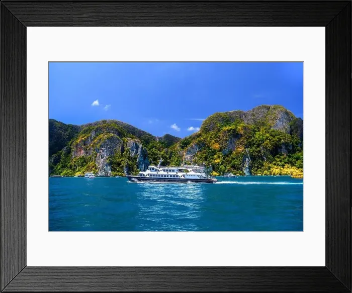 Framed Print : Motor ship in the bay of Ko Phi Phi Don Island with huge rocks and cliffs on a sunny day Framed Print : Motor ship in the bay of Ko Phi Phi Don Island with huge rocks and cliffs on a sunny day