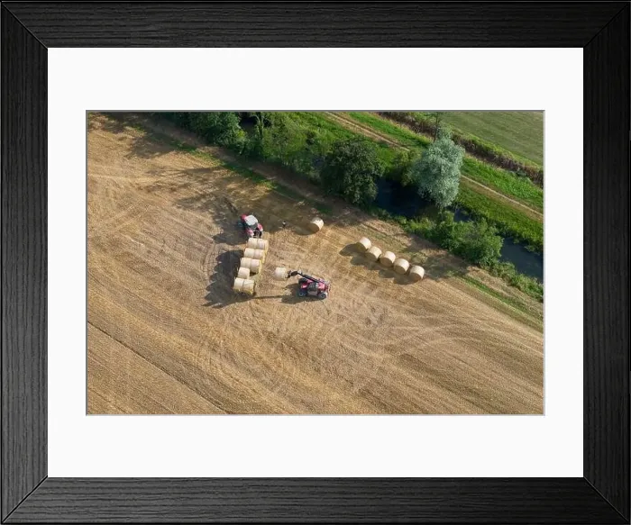 Framed Print : Aerial view of tractor collecting straw bales Framed Print : Aerial view of tractor collecting straw bales
