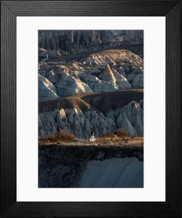 Framed Print : Stunning view of a person enjoying the view of some rock formations in the Red & Rose Valley in Cappadocia during a Framed Print : Stunning view of a person enjoying the view of some rock formations in the Red & Rose Valley in Cappadocia during a