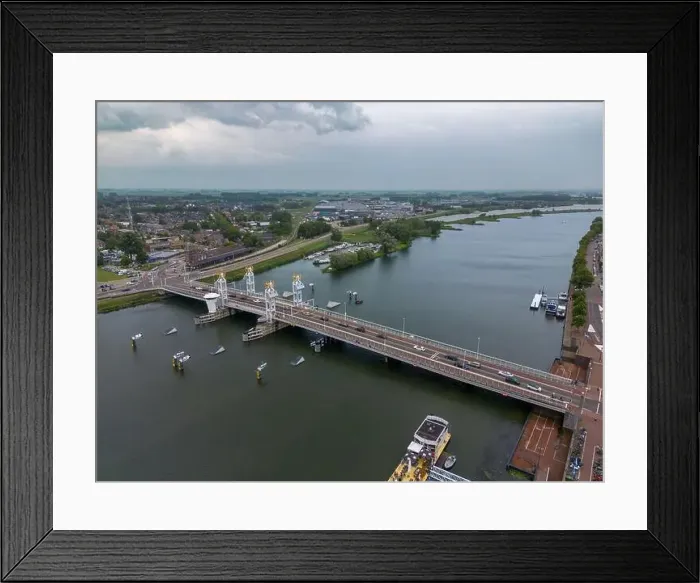 Framed Print : Aerial drone video of the bridge over the river Ijssel in Kampen. Kampen is a city in Overijssel, the Netherlands Framed Print : Aerial drone video of the bridge over the river Ijssel in Kampen. Kampen is a city in Overijssel, the Netherlands
