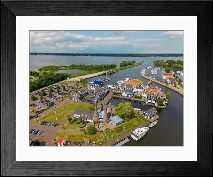 Framed Print : Aerial drone photo of the dutch town Huizen in Utrecht. It has a large marina with typical dutch houses Framed Print : Aerial drone photo of the dutch town Huizen in Utrecht. It has a large marina with typical dutch houses