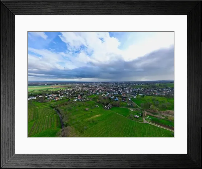 Framed Print : Uffholtz Winter Wonderland: Verdant Vineyards Embrace a Picturesque Village Amidst Stormy Skies Framed Print : Uffholtz Winter Wonderland: Verdant Vineyards Embrace a Picturesque Village Amidst Stormy Skies