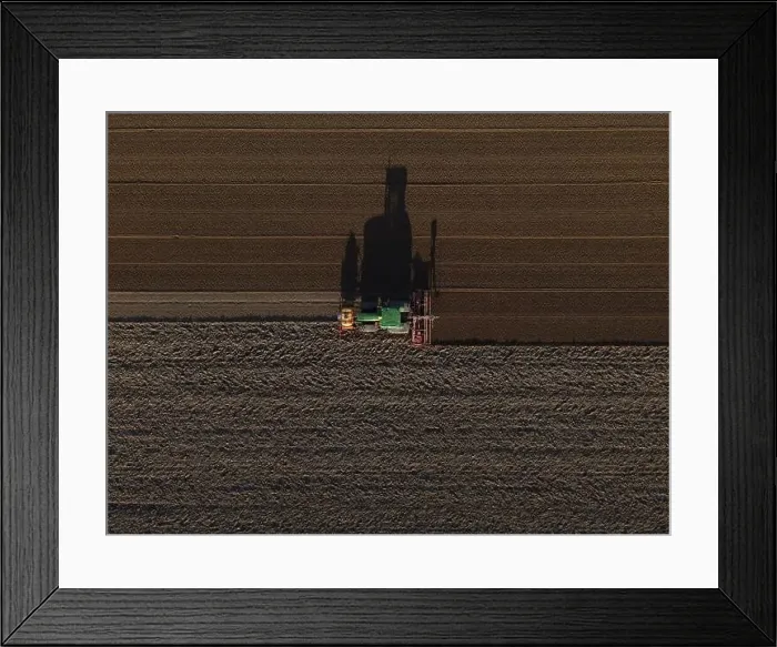 Framed Print : A John Deere Tractor seeds a previously cultivated field with sweetcorn, late in the evening Framed Print : A John Deere Tractor seeds a previously cultivated field with sweetcorn, late in the evening