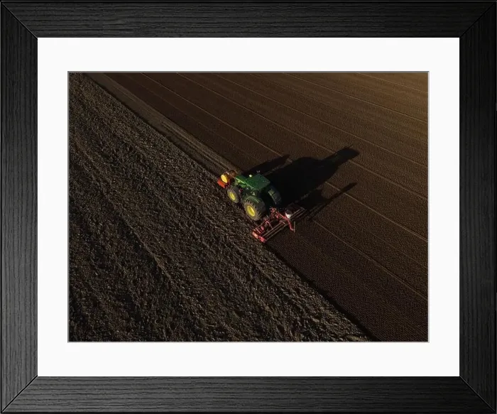 Framed Print : A John Deere Tractor seeds a previously cultivated field with sweetcorn, late in the evening Framed Print : A John Deere Tractor seeds a previously cultivated field with sweetcorn, late in the evening