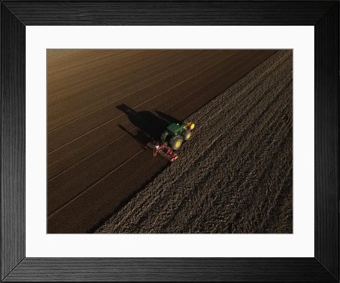Framed Print : A John Deere Tractor seeds a previously cultivated field with sweetcorn, late in the evening Framed Print : A John Deere Tractor seeds a previously cultivated field with sweetcorn, late in the evening