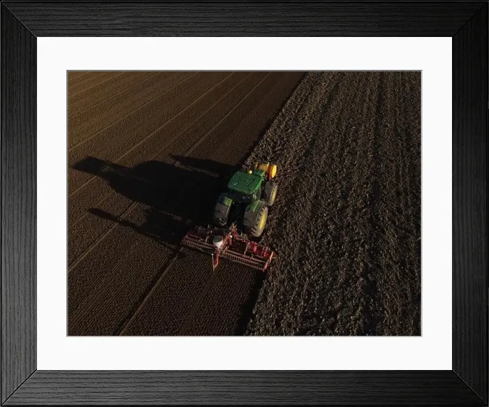 Framed Print : A John Deere Tractor seeds a previously cultivated field with sweetcorn, late in the evening Framed Print : A John Deere Tractor seeds a previously cultivated field with sweetcorn, late in the evening