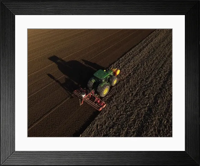 Framed Print : A John Deere Tractor seeds a previously cultivated field with sweetcorn, late in the evening Framed Print : A John Deere Tractor seeds a previously cultivated field with sweetcorn, late in the evening