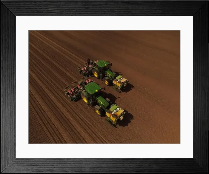Framed Print : Two John Deere tractors, seen from above, work together to plant a field with sweetcorn after it has been cultivated Framed Print : Two John Deere tractors, seen from above, work together to plant a field with sweetcorn after it has been cultivated