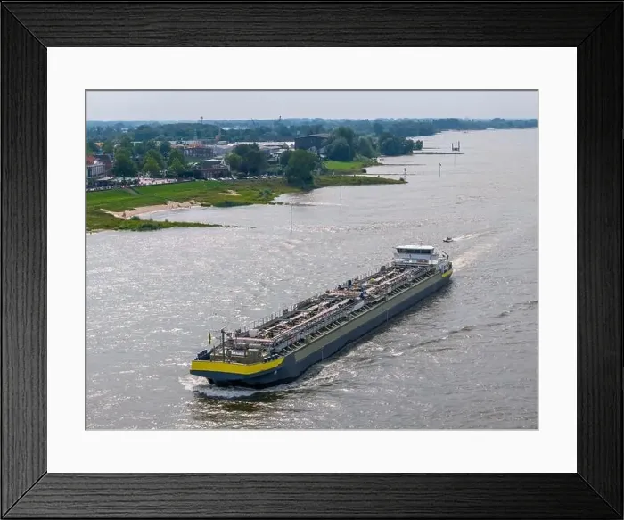 Framed Print : Aerial drone photo of a cargo ship on the river Waal in the Netherlands Framed Print : Aerial drone photo of a cargo ship on the river Waal in the Netherlands