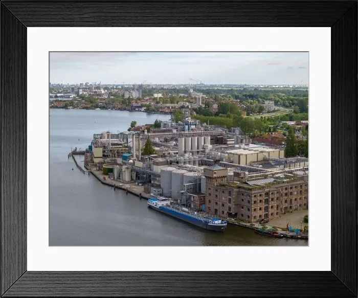 Framed Print : Aerial drone photo of a cargo barge docked at an industrial zone in Wormerveer, the Netherlands Framed Print : Aerial drone photo of a cargo barge docked at an industrial zone in Wormerveer, the Netherlands