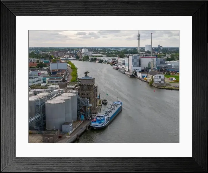 Framed Print : Aerial drone photo of a cargo barge docked at an industrial zone in Wormerveer, the Netherlands Framed Print : Aerial drone photo of a cargo barge docked at an industrial zone in Wormerveer, the Netherlands