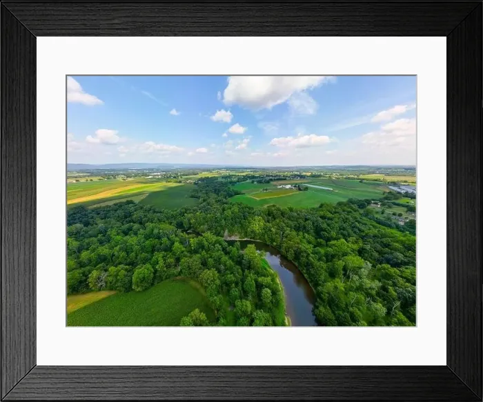 Framed Print : Aerial drone view over creek during daytime with trees in few and harsh sunlight Framed Print : Aerial drone view over creek during daytime with trees in few and harsh sunlight