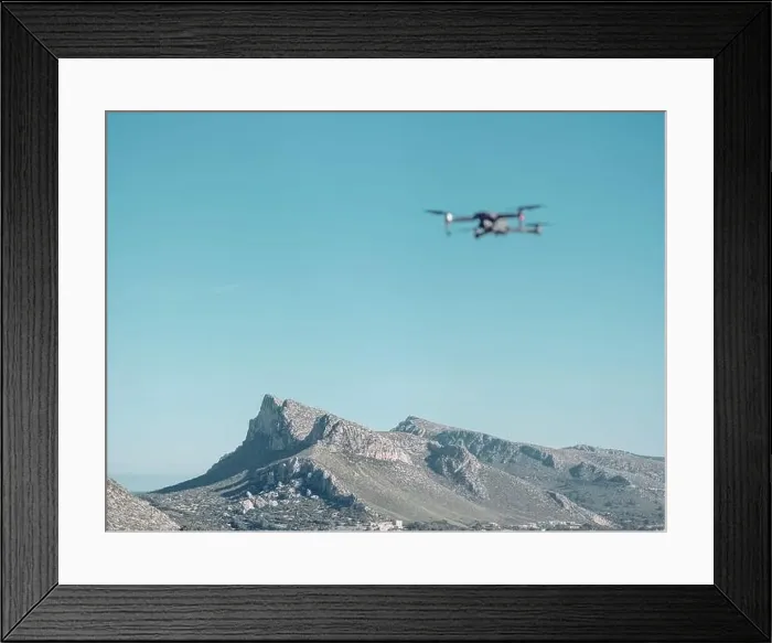 Framed Print : Blurred drone flying in cloudless blue sky over peaks of scenic mountain ridge near Pollensa town on sunny day in Framed Print : Blurred drone flying in cloudless blue sky over peaks of scenic mountain ridge near Pollensa town on sunny day in