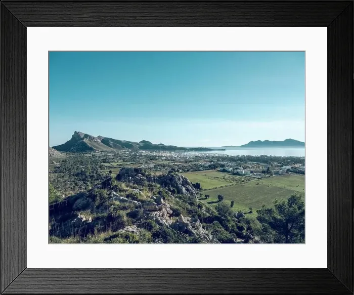 Framed Print : Picturesque drone view of Pollensa town located amidst green agricultural fields Framed Print : Picturesque drone view of Pollensa town located amidst green agricultural fields