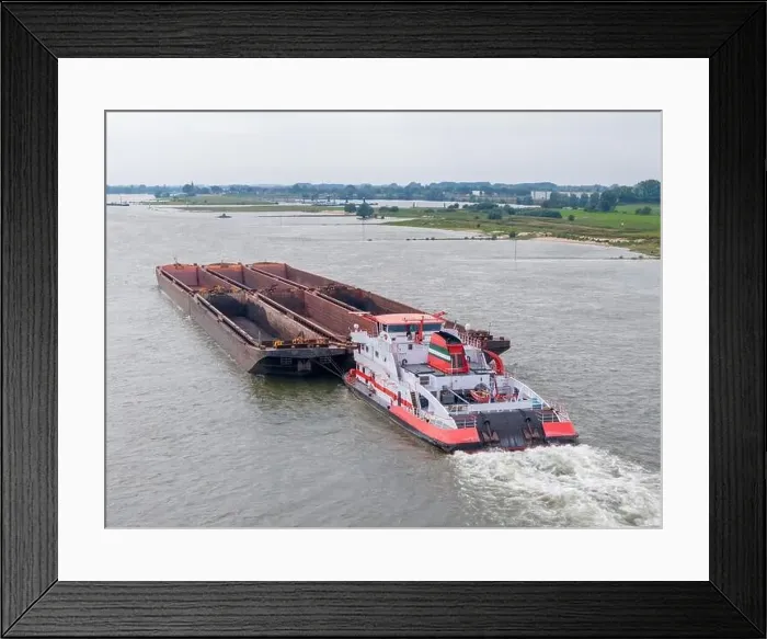 Framed Print : Aerial drone photo of a large cargo barge sailing on the river Waal in the Netherlans Framed Print : Aerial drone photo of a large cargo barge sailing on the river Waal in the Netherlans
