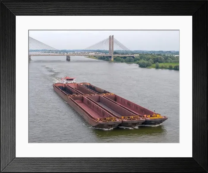 Framed Print : Aerial drone photo of a large cargo barge sailing on the river Waal in the Netherlans Framed Print : Aerial drone photo of a large cargo barge sailing on the river Waal in the Netherlans