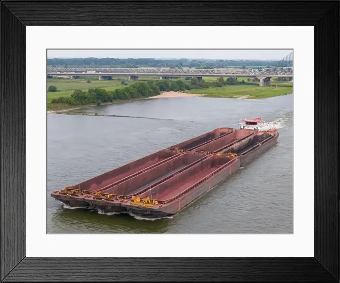 Framed Print : Aerial drone photo of a large cargo barge sailing on the river Waal in the Netherlans Framed Print : Aerial drone photo of a large cargo barge sailing on the river Waal in the Netherlans