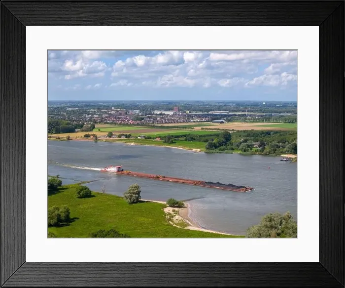 Framed Print : Aerial drone photo of a large cargo barge sailing on the river Waal in the Netherlans Framed Print : Aerial drone photo of a large cargo barge sailing on the river Waal in the Netherlans