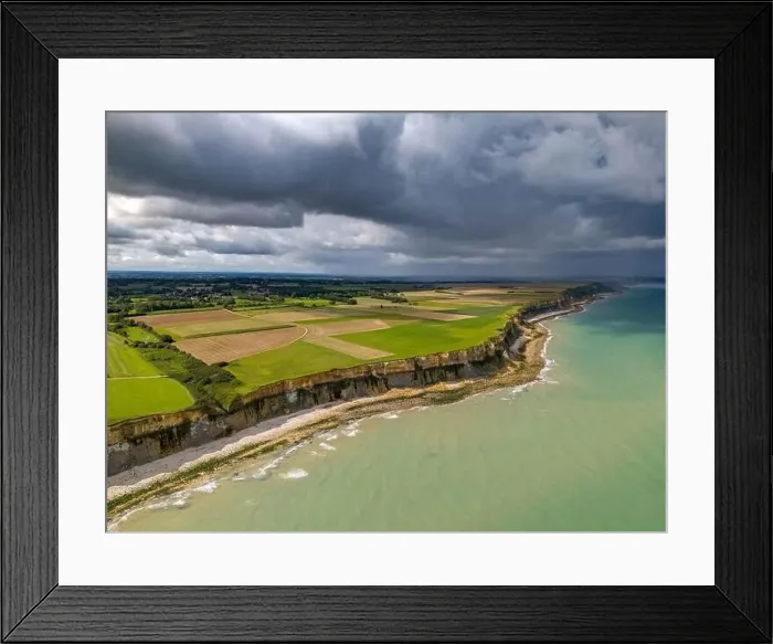 Framed Print : Aerial view of the beautiful coastline near Arromanches in Normandy, France. High cliffs rise above the sea Framed Print : Aerial view of the beautiful coastline near Arromanches in Normandy, France. High cliffs rise above the sea