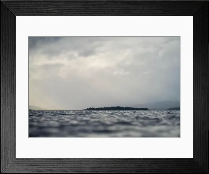 Framed Print : rays through clouds over the water