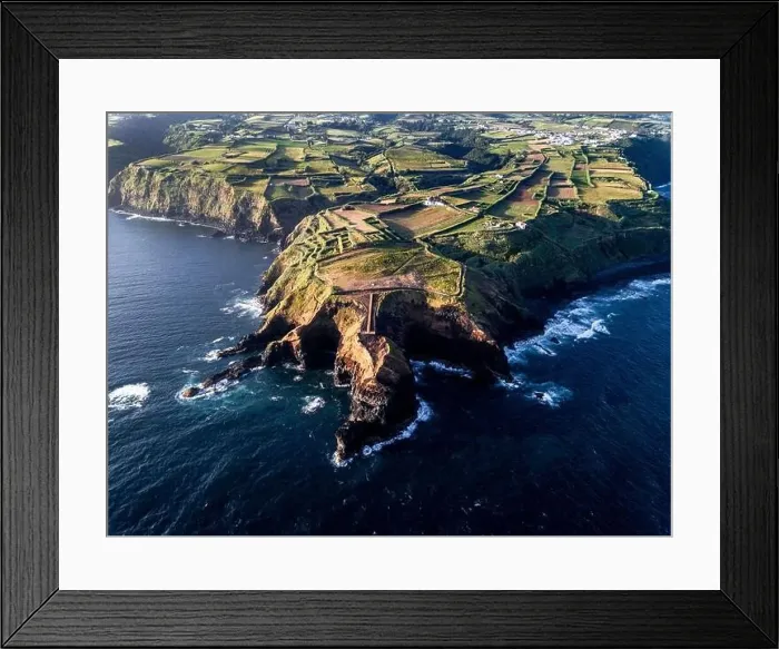 Framed Print : Aerial view of the coasts and cliffs of the island of Sao Miguel over the lighthouse of Farolim dos Fenais da Ajuda Framed Print : Aerial view of the coasts and cliffs of the island of Sao Miguel over the lighthouse of Farolim dos Fenais da Ajuda