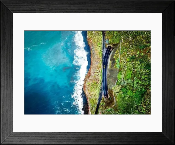 Framed Print : Beautiful and stunning bird's eye view of a yellow car driving between two tunnels on a cliff road in Madeira, Portugal