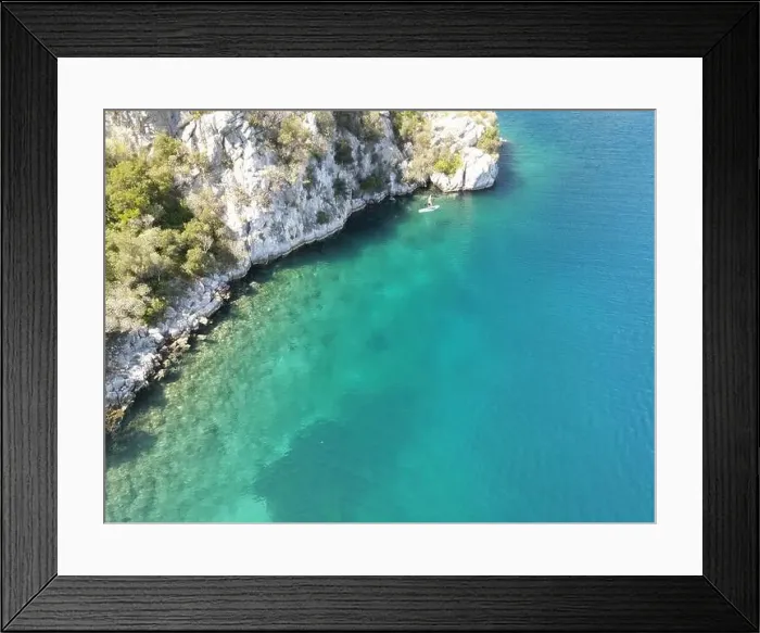 Framed Print : Panoramic drone photo of the tropical beach and a SUP paddleboard in the bay of Toroni in Halkidiki, Greece Framed Print : Panoramic drone photo of the tropical beach and a SUP paddleboard in the bay of Toroni in Halkidiki, Greece