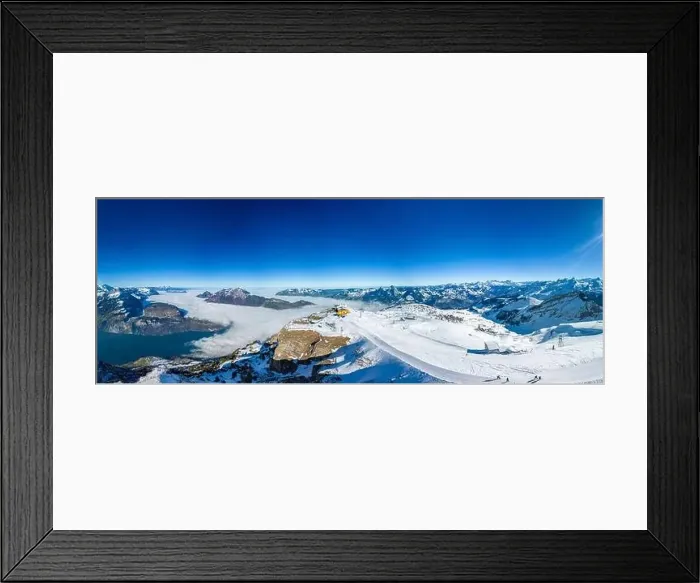 Framed Print : Aerial drone view of snow covered mountains and ski slopes, ski area Stoos, Switzerland Framed Print : Aerial drone view of snow covered mountains and ski slopes, ski area Stoos, Switzerland