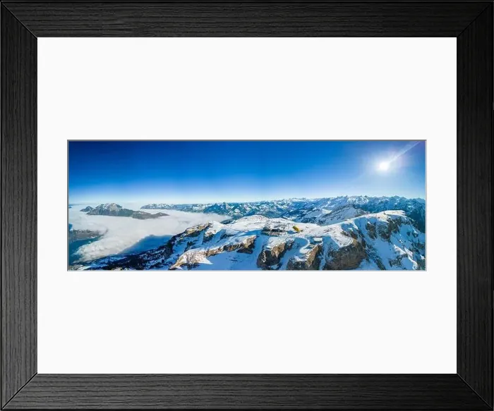 Framed Print : Aerial drone view of snow covered mountains and ski slopes, ski area Stoos, Switzerland Framed Print : Aerial drone view of snow covered mountains and ski slopes, ski area Stoos, Switzerland