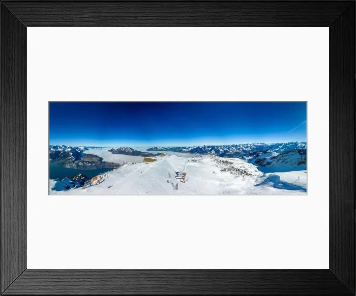 Framed Print : Aerial drone view of snow covered mountains and ski slopes, ski area Stoos, Switzerland Framed Print : Aerial drone view of snow covered mountains and ski slopes, ski area Stoos, Switzerland