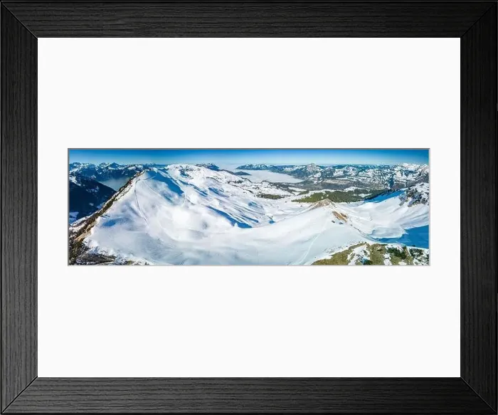 Framed Print : Aerial drone view of snow covered mountains and ski slopes, ski area Stoos, Switzerland Framed Print : Aerial drone view of snow covered mountains and ski slopes, ski area Stoos, Switzerland