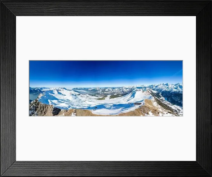 Framed Print : Aerial drone view of snow covered mountains and ski slopes, ski area Stoos, Switzerland Framed Print : Aerial drone view of snow covered mountains and ski slopes, ski area Stoos, Switzerland