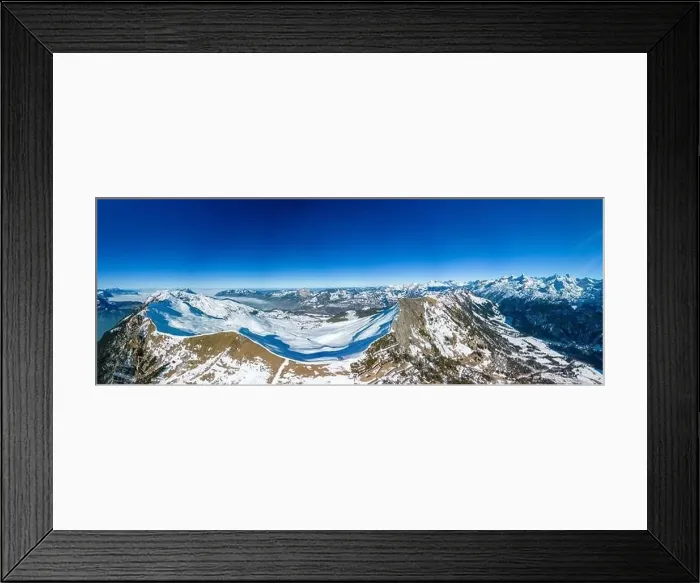 Framed Print : Aerial drone view of snow covered mountains and ski slopes, ski area Stoos, Switzerland Framed Print : Aerial drone view of snow covered mountains and ski slopes, ski area Stoos, Switzerland