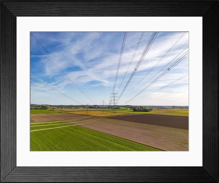 Framed Print : Rural nature landscape in conflict with artificial structures of power poles Framed Print : Rural nature landscape in conflict with artificial structures of power poles